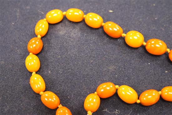 A single strand graduated oval amber bead necklace, gross weight 53 grams, approx. 62cm.